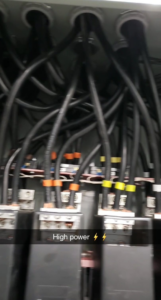 High power electrical panel with multiple thick wires and colored tape, showcasing work by Delta Electric in Germantown, MD.