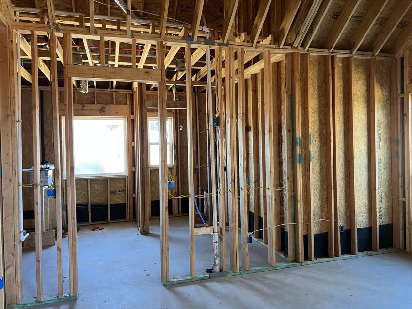 Electrical rough-in for a new home, showing wiring and outlet boxes by TJAM Electric in Springtown, TX.