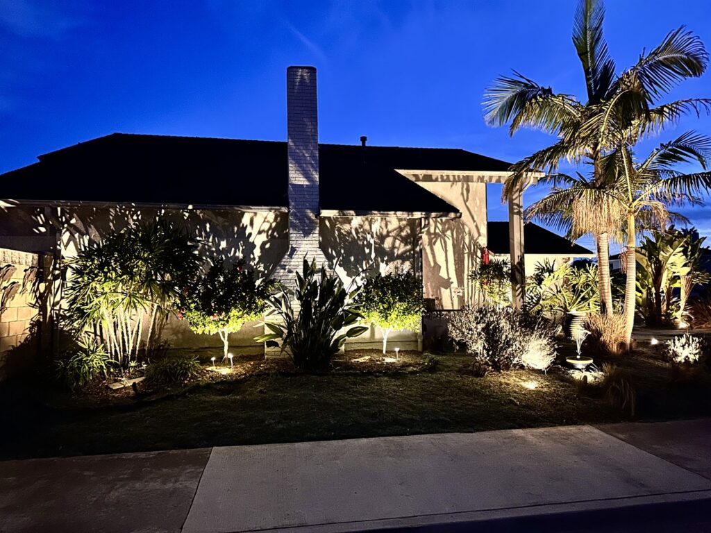 A home exterior enhanced with professional landscape lighting, showcasing the work of GL3 Luxury Lighting in Anaheim, CA.