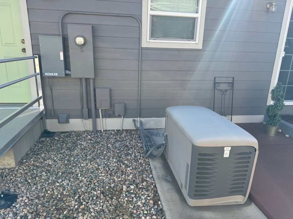 A home standby generator and electrical meter installation on the exterior of a house by AC-DC Electric in Severance, CO.