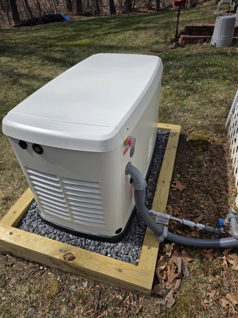 A home standby generator installation showing gas and electrical connections by Cason Power Solutions in Lowell, MA