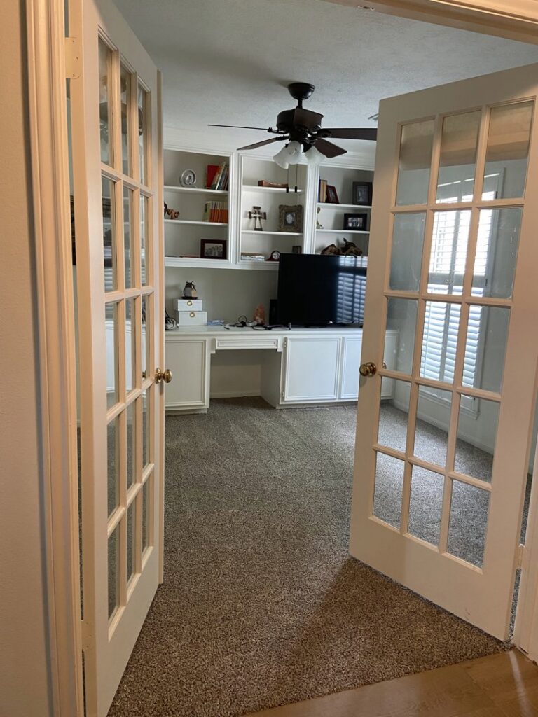 A home office with built-in shelving and new carpet installation by Castro's Carpet in Houston, TX.