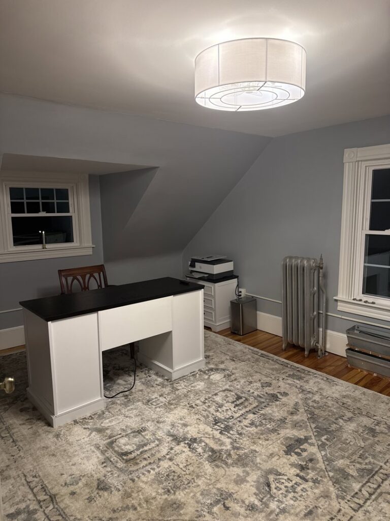 A home office with a new ceiling light fixture installed by EPOS Systems, Inc. in West Springfield, MA.
