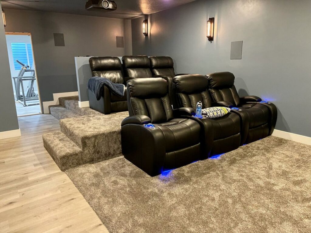 A luxurious home theater room with new carpeted steps and floor by All about flooring utah in Salt Lake City, UT.