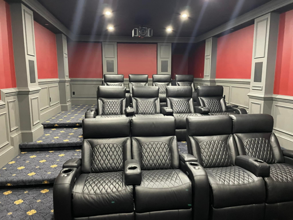 A home theater with a ceiling-mounted projector and recessed lighting installed by Heritage Electric in Bluffton, SC.
