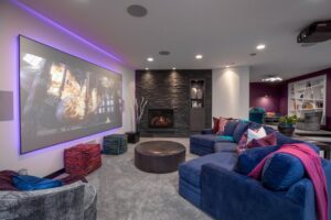 A luxurious home theater room featuring plush gray carpet installed by Carpet World Fargo, ND