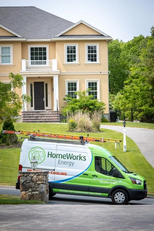 A HomeWorks Energy HVAC service van parked in front of a residential home in Charlestown, MA.