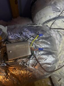 A Honeywell control box installed on insulated HVAC ductwork, indicating a system component serviced by Air Casablanca Heating & Cooling in Myrtle Beach, SC.