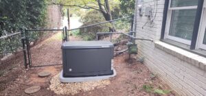 A Honeywell standby generator professionally installed next to a house, showing gas and electrical connections in Atlanta, GA.