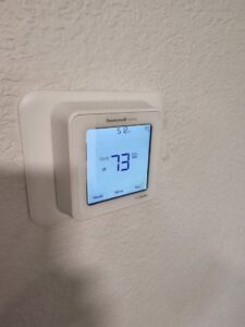 A close-up of a modern Honeywell Home smart thermostat, representing a typical installation or upgrade by One Hour Air Conditioning & Heating of Fort Worth, TX.
