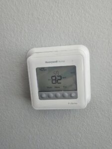 A Honeywell Home thermostat on a wall displaying temperature settings, serviced by Desert Air, LLC in Sun Valley, NV.