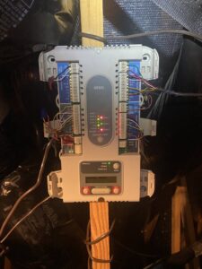 An open Honeywell HVAC zone control panel showing wiring and indicator lights by Reasonable Air, LLC in Summerville, SC.