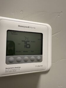 A Honeywell Home thermostat installed by Bergmann Heating & Air Conditioning, LLC, showing temperature settings in Orem, UT