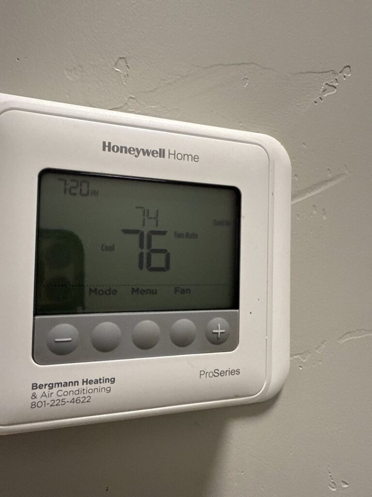 A Honeywell Home thermostat installed by Bergmann Heating & Air Conditioning, LLC, showing temperature settings in Orem, UT