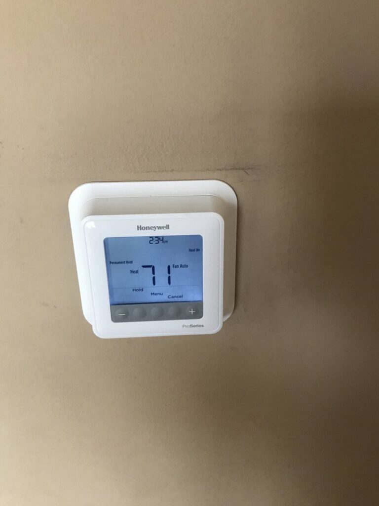 A Honeywell ProSeries thermostat installed on a wall by Comforttechs in Lincoln, NE.