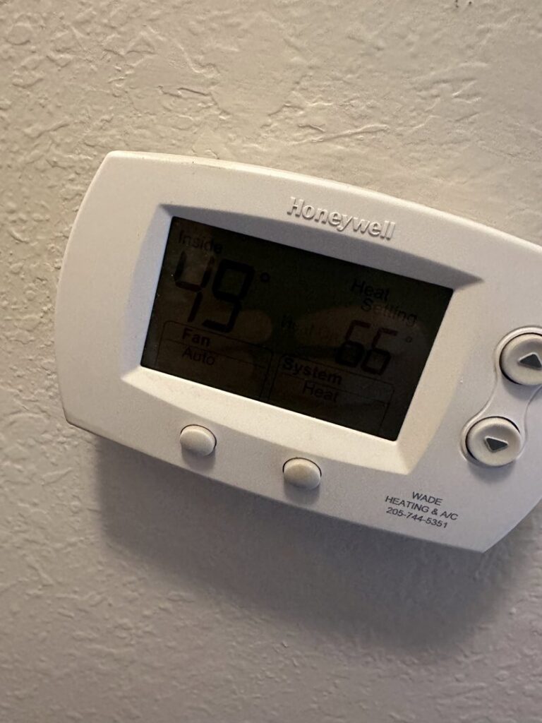 A Honeywell thermostat displaying temperature settings on a wall, installed or serviced by McNeal and Sons Electrical and HVAC in Birmingham, AL.