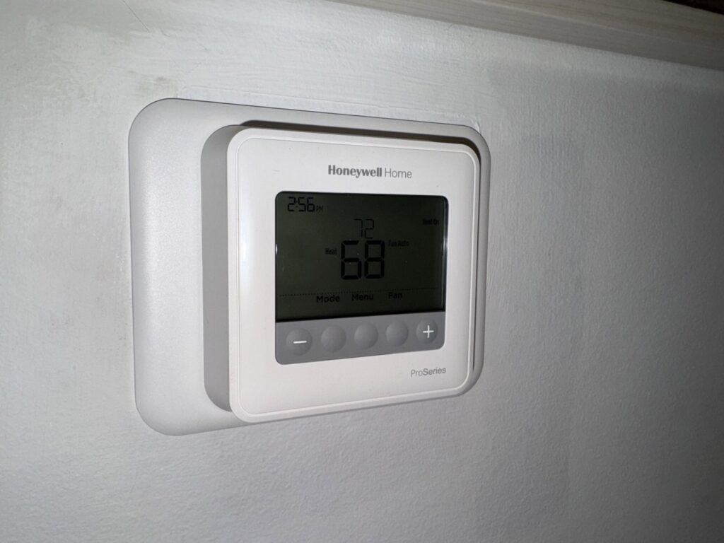 A Honeywell ProSeries thermostat installed on a wall, representing services by Trenary Service Company in Martinsburg, WV.