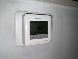 A Honeywell ProSeries thermostat installed on a wall, representing services by Trenary Service Company in Martinsburg, WV.