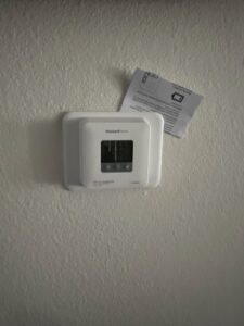 A Honeywell thermostat installed on a wall, representing services by Usa Air Conditioning & Heating in Las Vegas, NV