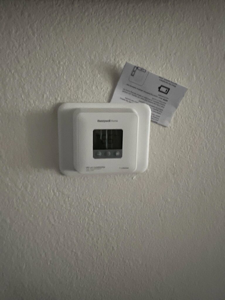 A Honeywell thermostat installed on a wall, representing services by Usa Air Conditioning & Heating in Las Vegas, NV