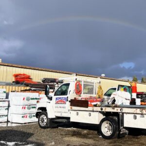 A Horizon Fence & Custom Gates, Inc. work truck loaded with fencing materials under a rainbow in Orangevale, CA.