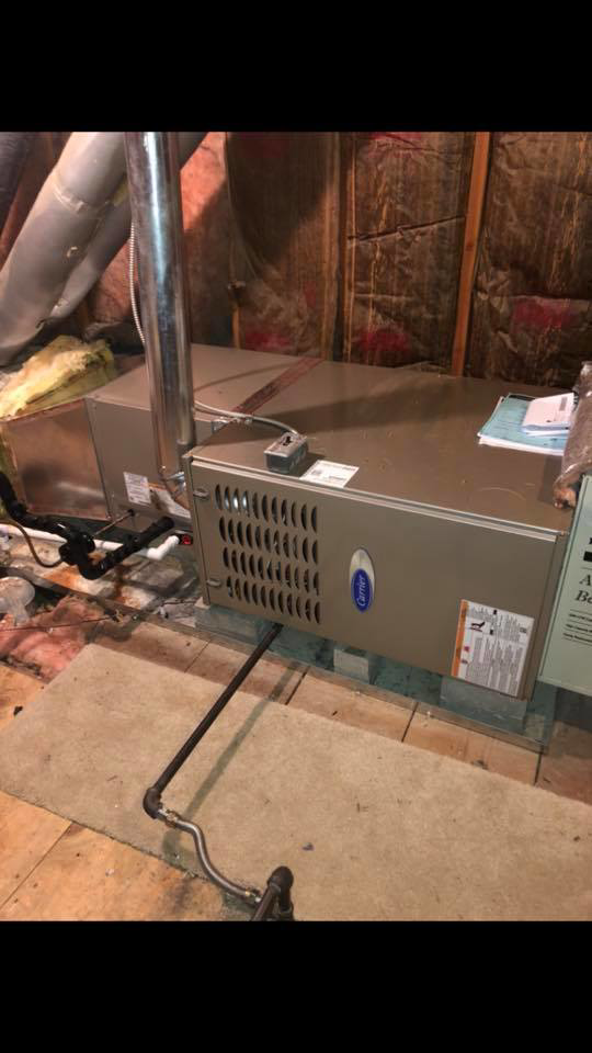 A horizontal Carrier furnace installation with ductwork and piping by Arrowhead Mechanical HVAC in Woodville, OH