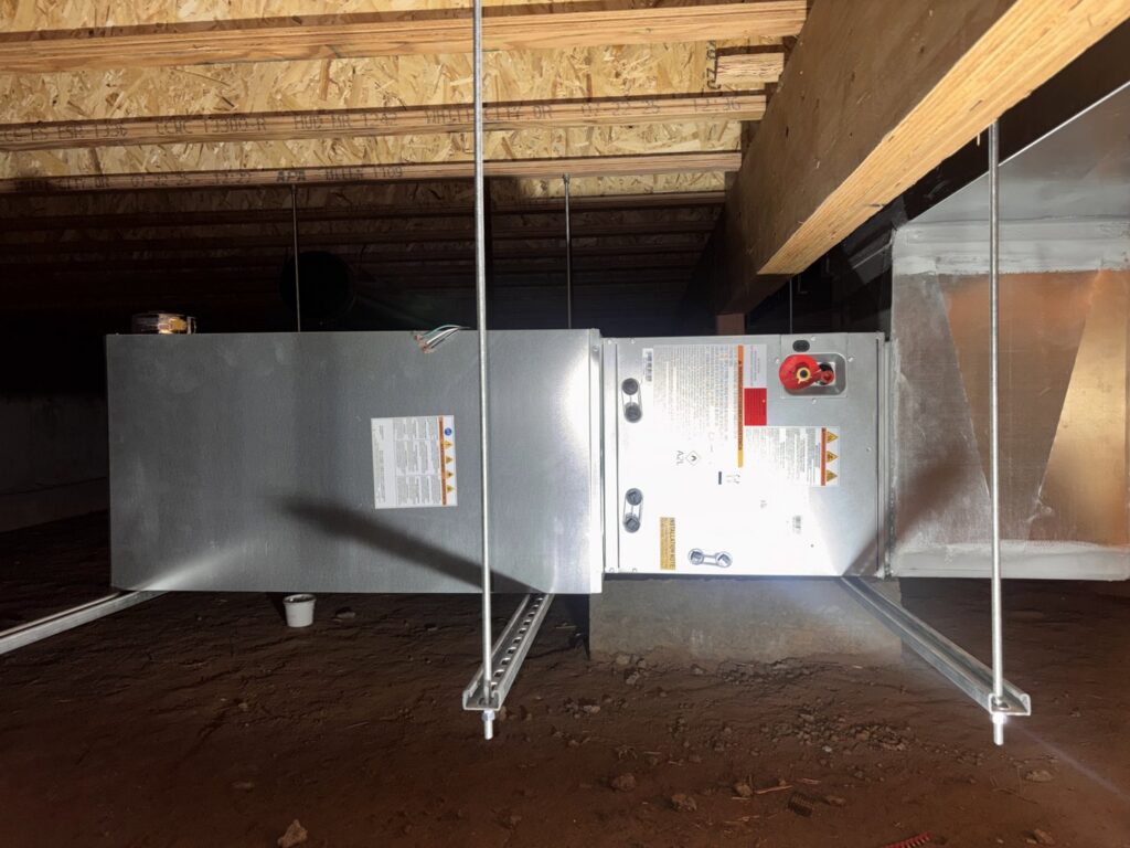 Horizontal HVAC ductwork and an air handler unit installed in a crawl space by Lee's Heating & Cooling in Pueblo, CO.