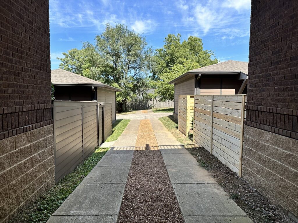 A horizontal slat wooden fence installed next to a shed, viewed from above, by Fenceworks of Middle Tennessee in Nashville, TN.