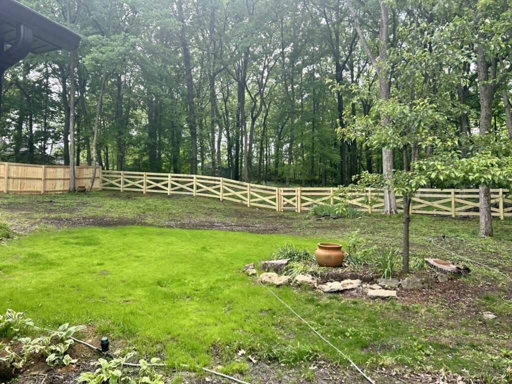 Horizontal slat wooden fences creating a pathway between buildings by Fenceworks of Middle Tennessee in Nashville, TN.
