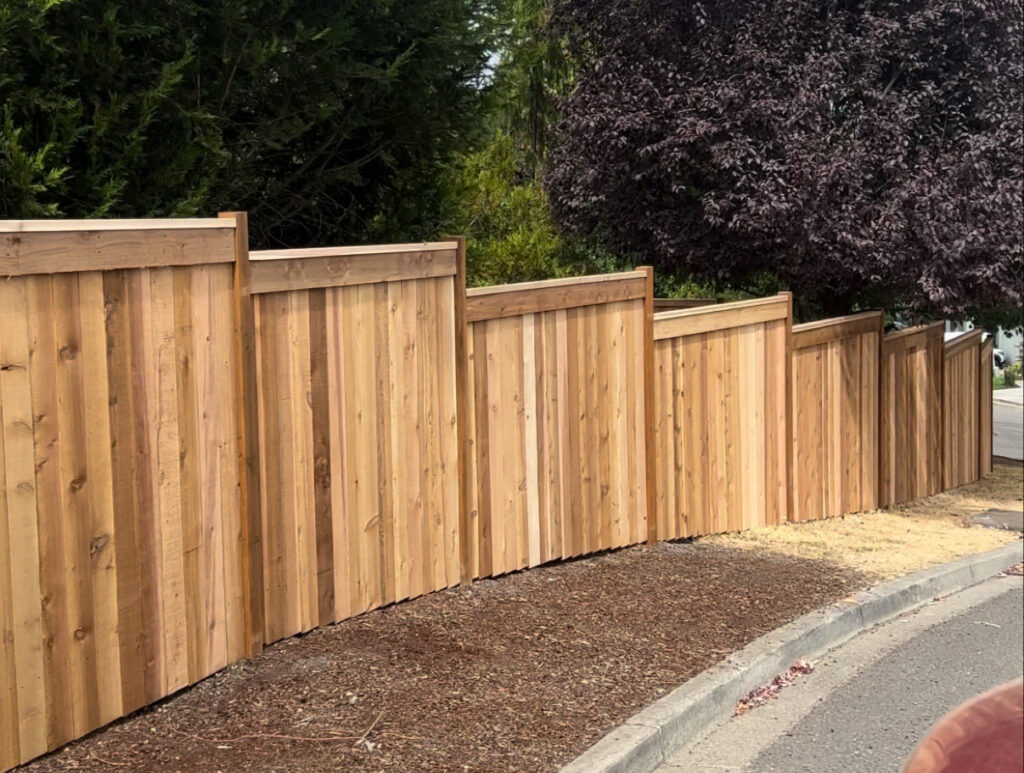 A modern horizontal slat wood privacy fence installed along a residential street by Clark County Fence LLC in Vancouver, WA.