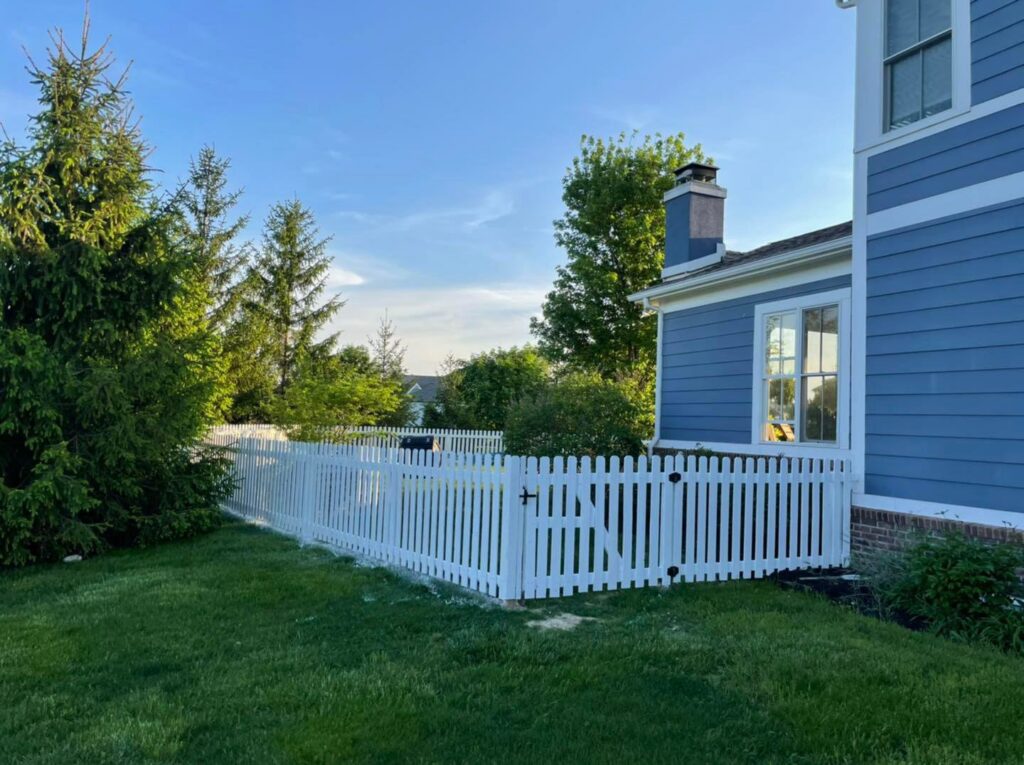 A modern horizontal slat wooden fence with a gate, installed by Hoplite Services in Indianapolis, IN.