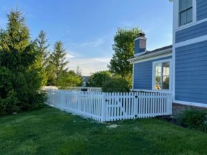 A modern horizontal slat wooden fence with a gate, installed by Hoplite Services in Indianapolis, IN.