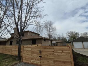 A newly installed horizontal wood fence with a gate by Supreme Fencing Denver, CO.