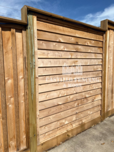 A sturdy horizontal wood plank fence installed by Castillo Fencing & More in Corpus Christi, TX.