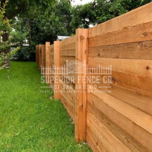 A newly installed horizontal wood plank fence providing privacy and style by Superior Fence Co. of San Antonio, TX.
