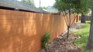 A modern horizontal wood plank privacy fence installed by Serrato's Fence & Welding in San Antonio, TX.