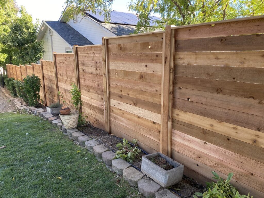 A horizontal wood privacy fence installed in a residential backyard by ZBros Fencing LLC in Boise, ID.