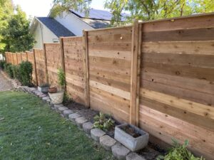 A horizontal wood privacy fence installed in a residential backyard by ZBros Fencing LLC in Boise, ID.