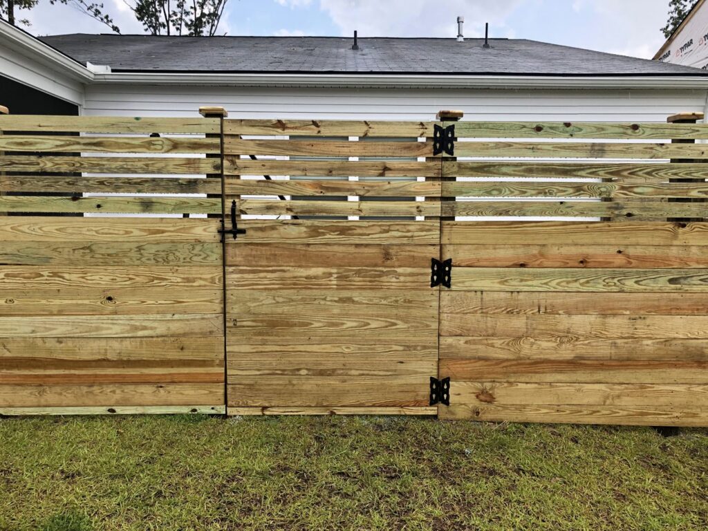 A modern horizontal wood privacy fence with a matching gate, installed by Charleston Fencing Services in Moncks Corner, SC.
