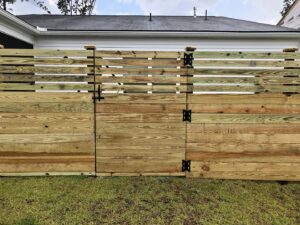 A modern horizontal wood privacy fence with a matching gate, installed by Charleston Fencing Services in Moncks Corner, SC.