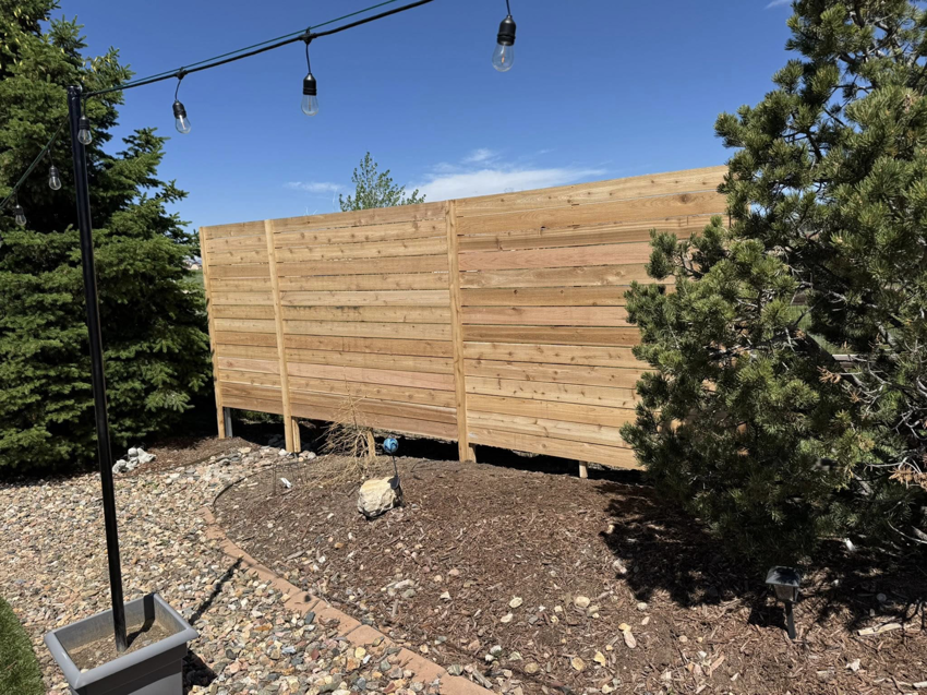 A newly installed horizontal wood privacy fence in a residential backyard by Slater Fence Co in Houston, TX.