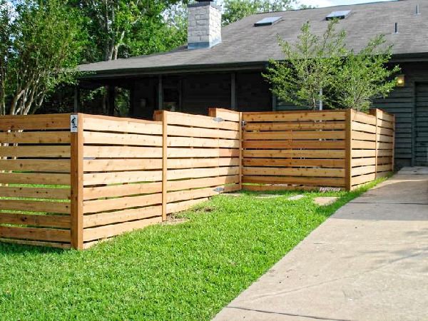A modern horizontal wood slat fence enclosing a residential property, installed by Ozark Fence in Lakewood, CO.