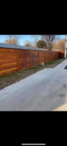 A newly installed horizontal wooden fence running alongside a concrete path by G Squared Fencing & Services LLC in New Braunfels, TX.