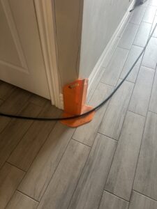 A hose protector in place on a tiled floor, part of the professional carpet cleaning setup by Extra Mile Floor Care in Mesa, AZ.