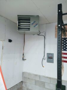 A 'Hot Dawg' garage heater installed on a wall, a heating service offered by TruTemp Heating & Cooling LLC in Ijamsville, MD.