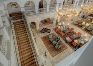 An elegant hotel lobby featuring multiple area rugs and a carpeted staircase, demonstrating work by Woven Legends in Philadelphia, PA.