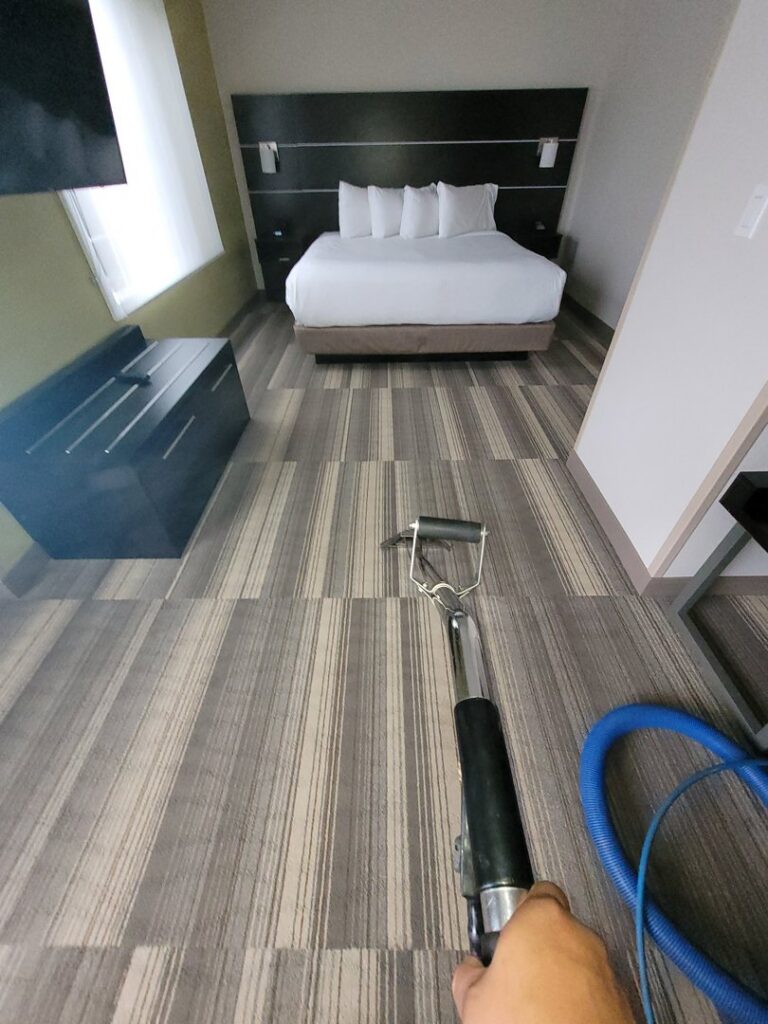 Carpet cleaning wand in use on striped carpet in a hotel room by PDX STAR in Happy Valley, OR