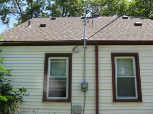 An exterior view of a house showing an electrical mast and meter installed by Mac Electric Company in Warren, MI.