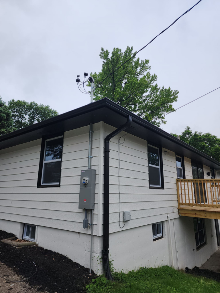 Exterior of a house showing the electrical meter and service mast installed by ATW Electric in Kansas City, MO.