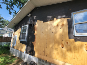 Exterior of a house with an electrical meter box, showing construction context by John Kivel Electric, LLC in Woodbury, MN.